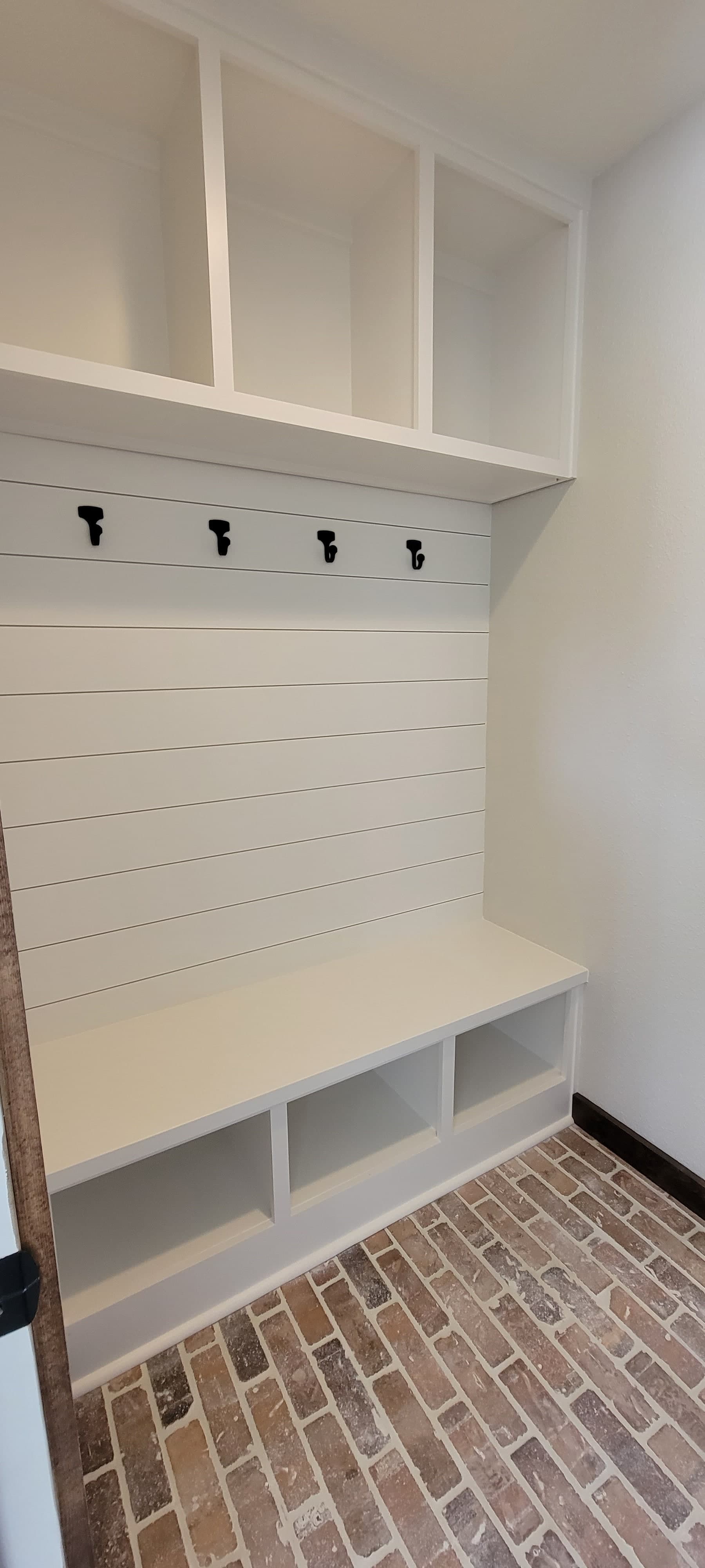 Mudroom — Shiplap, cubbies, and coat hooks